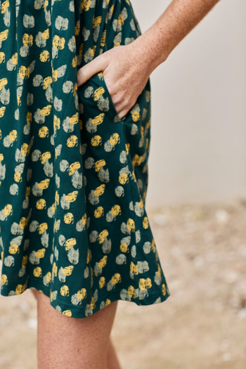 Vestido casual de flores vibrantes, verde con detalles amarillos, ideal para días cálidos.